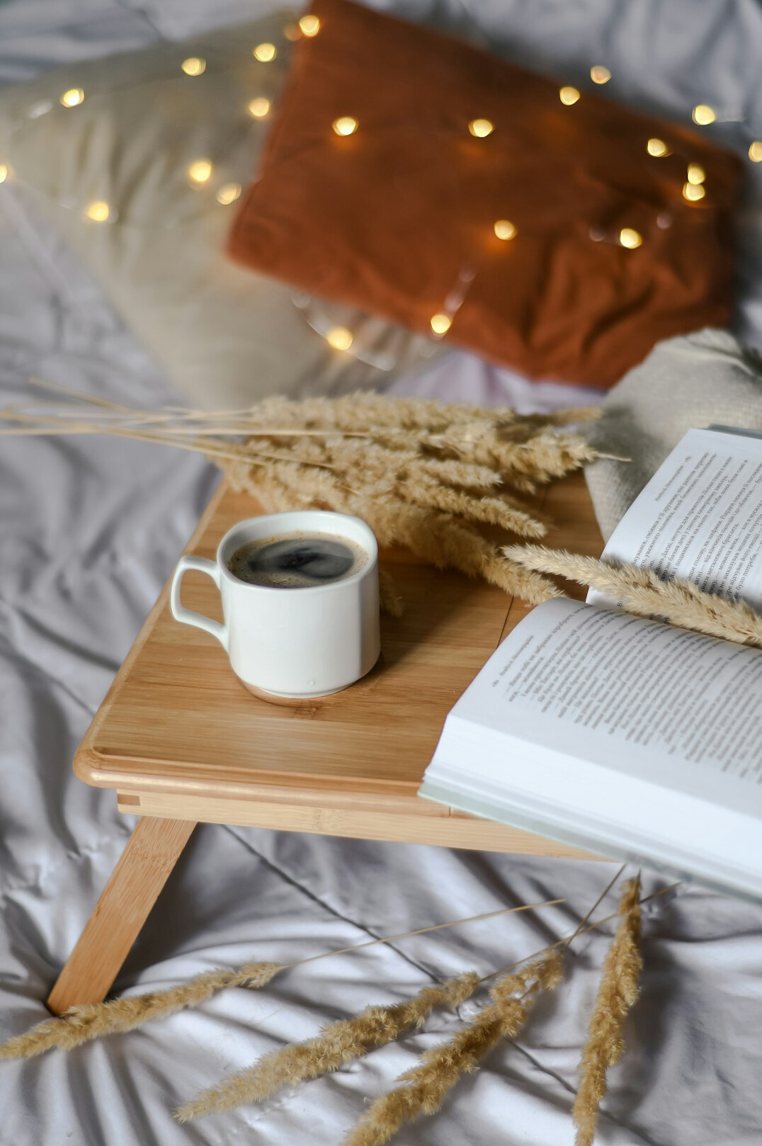 Open notebook with a cup of coffee on a table