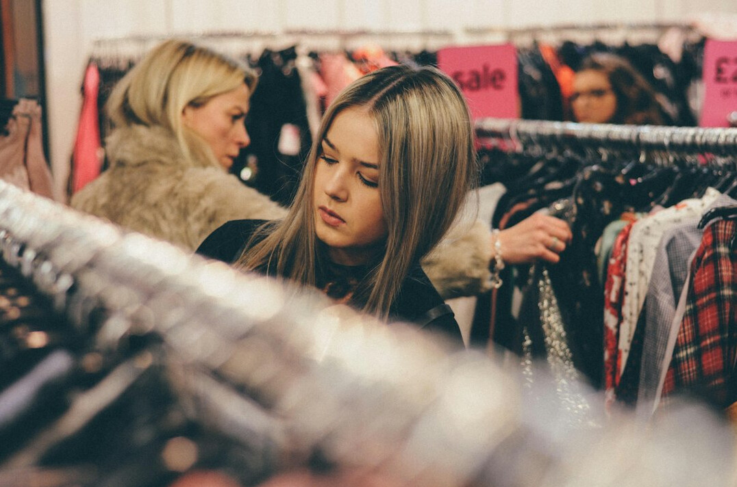 woman stealing clothes in store